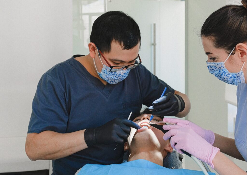 Dentist examining a patient during a consultation to evaluate whether a dental implant removal procedure is necessary.
