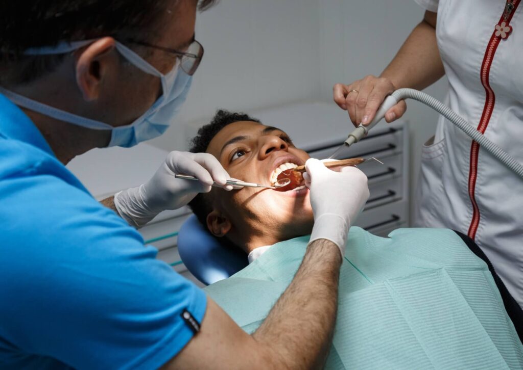 Dentist performing a tooth extraction procedure, showing the clinical steps involved and how long a tooth extraction typically takes.