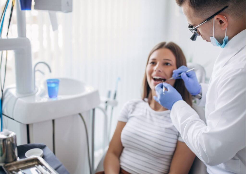 Dentist examining a patient's smile to evaluate porcelain veneers and discuss how long porcelain veneers typically last with proper care.