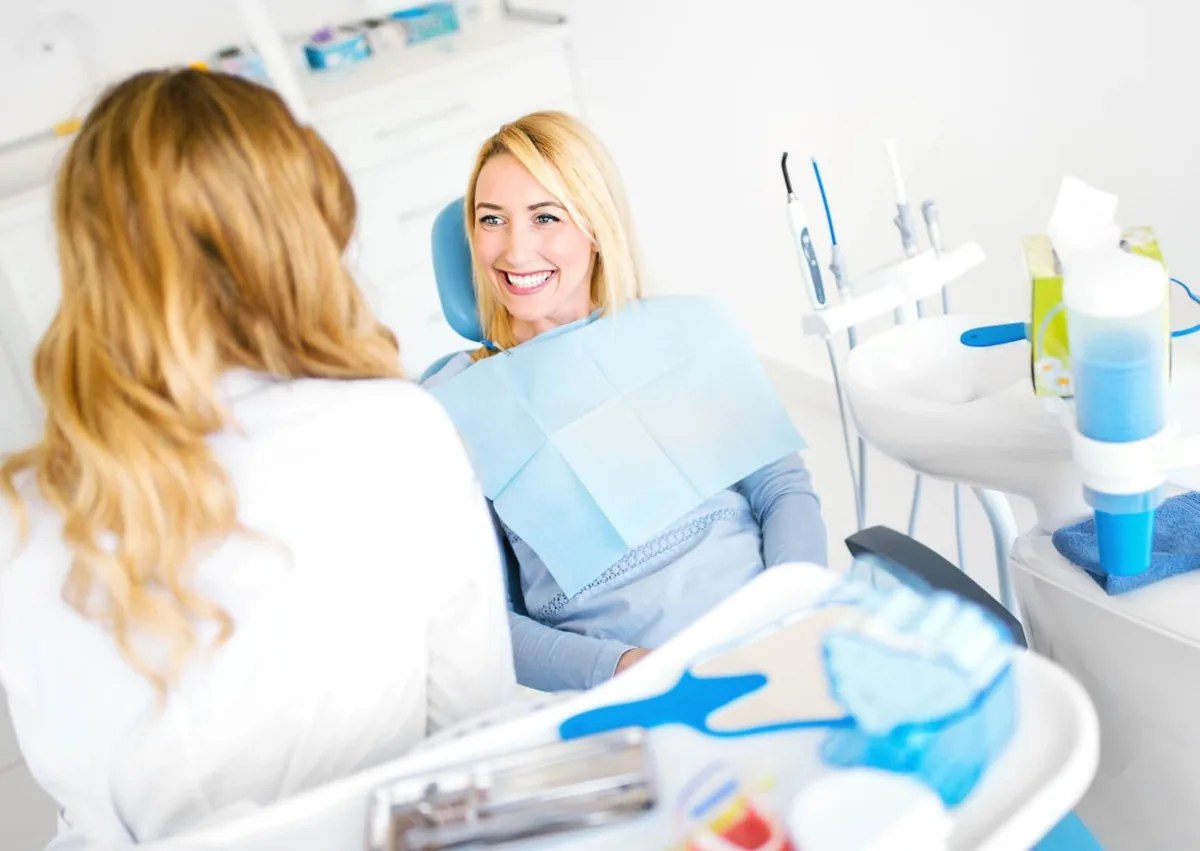 Patient discussing dental implant pros and cons with a dentist during a consultation.