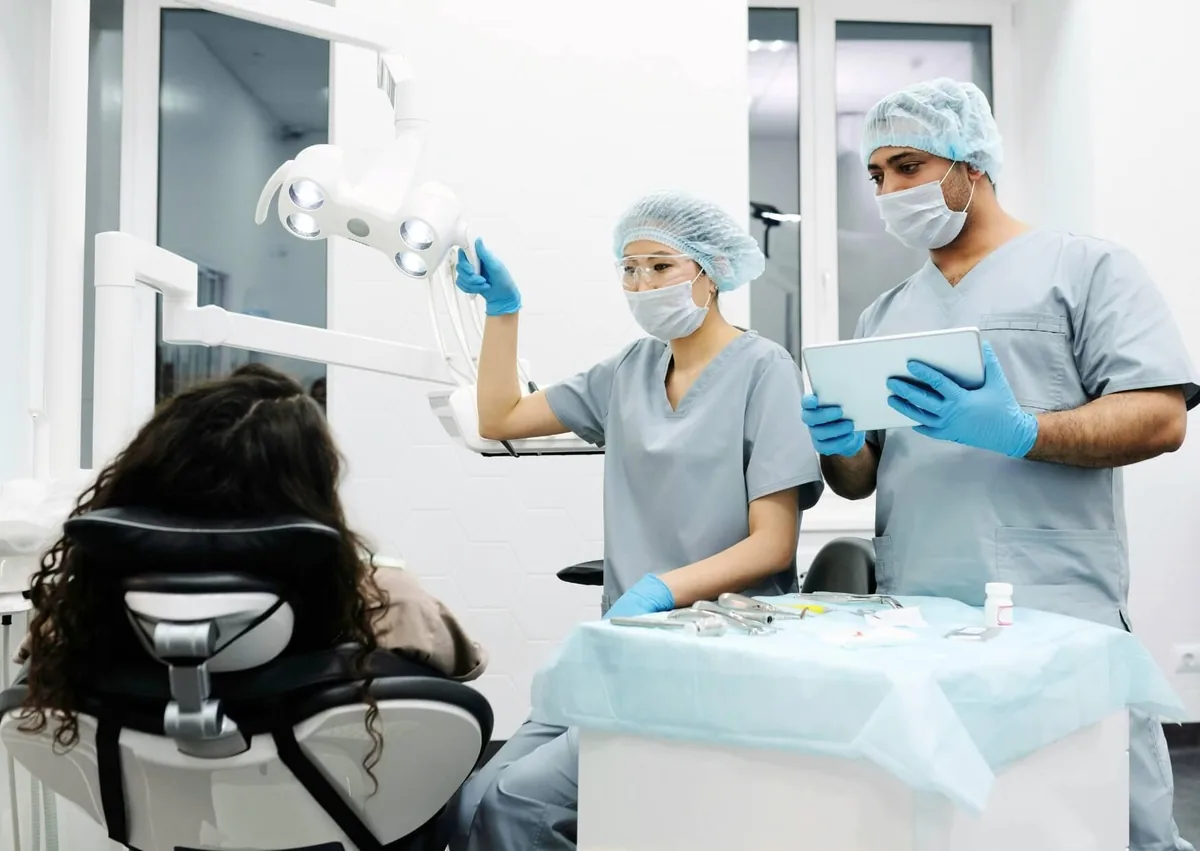 Dental team discussing recovery and long-term maintenance after zygomatic dental implant treatment.